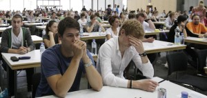 FILE - In this July 8, 2011 file photo applicants for the medical university sit in a hall of the Vienna Fair prior to their tests, in Vienna, Austria. The university says that this year's applicants to medical school will be graded according to gender, with the results weighed toward women. Deputy dean of studies Karien Guiterrez-Lobos says an unspecified "adjustment factor" will be included in female applicants' results when they are graded on July 6 entry exams. She told the Austria Press Agency Wednesday, March 14, 2012, that results will then be evaluated to see if the measures should be made permanent. (AP Photo/dapd, Lilli Strauss, File)